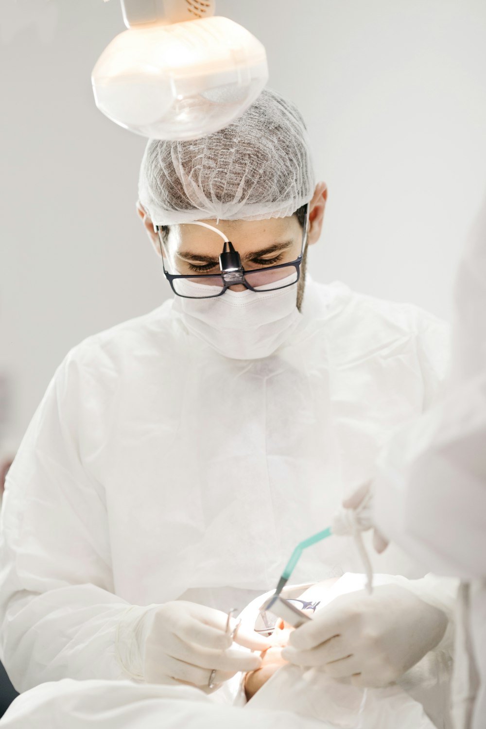 Pearline dentist focused on a patient treatment in Dhaka